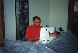 Tom sewing the bug tent.