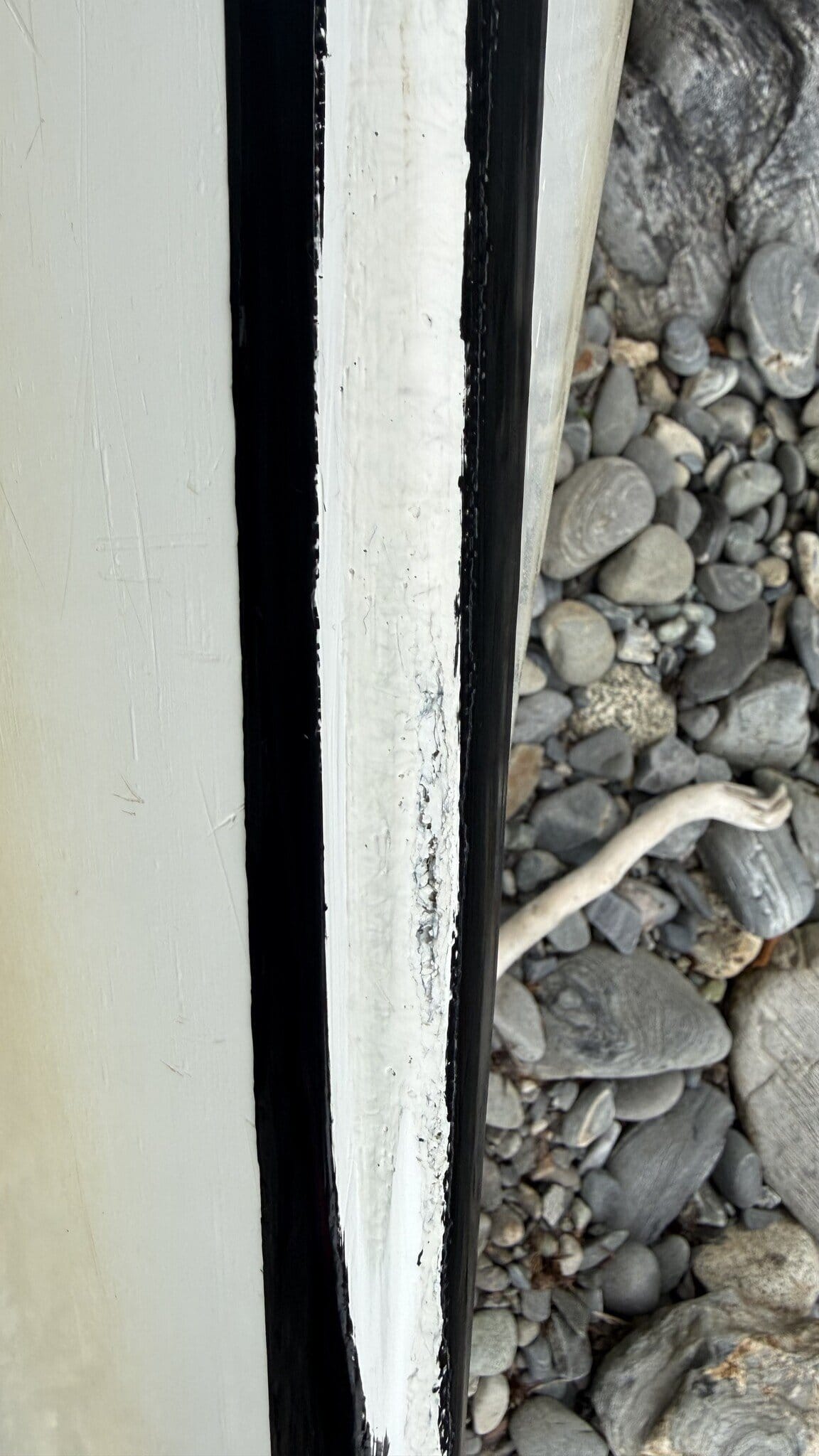 An image of a sea kayak keel with repair.